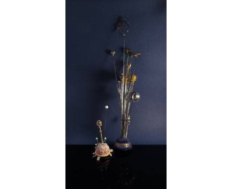 A quantity of ladies hat pins in two stands including 9ct, crystal and mother of pearl 