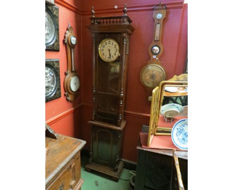 An Edwardian longcase clock with spindle top above circular dial