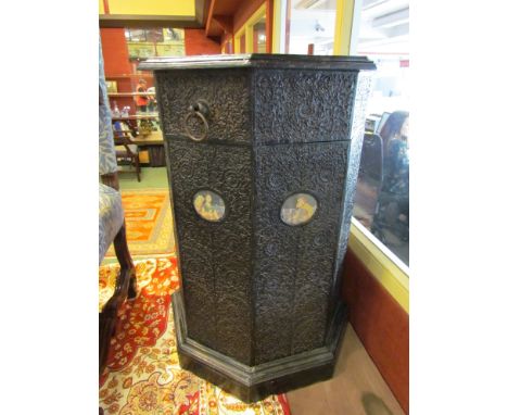 A 19th Century Anglo-Indian octagonal pedestal, hinged lid, profusely carved foliage, ebonised, portrait roundels   