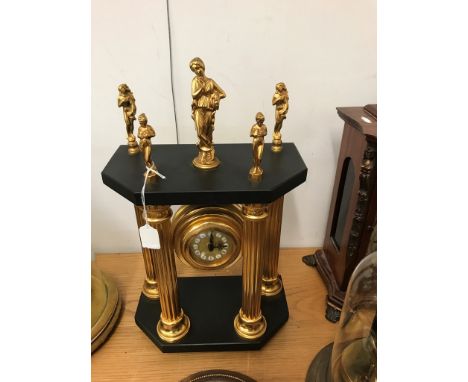 A 19th century-style portico clock with five women finials to the top