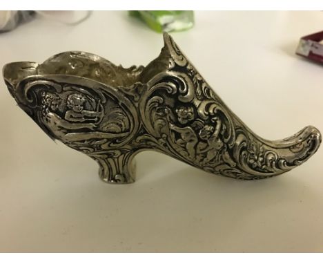 A large silver model of a shoe
