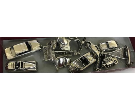 A quantity of silver model cars and boats