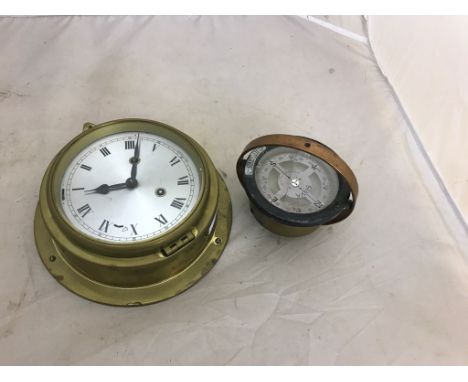 An old brass striking ship's clock and compass
