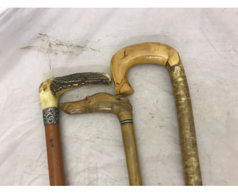 A horn, dog's head carved walking stick; together with a shepherd's crook