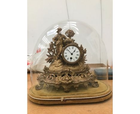 A 19th century gilt mantel clock enclosed in a glass dome