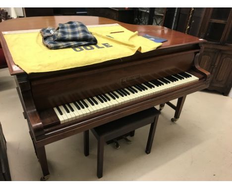 A baby grand piano by A R Goetze: twin pedalled model