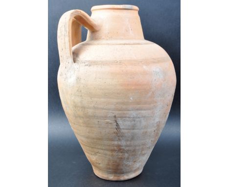 A 20th Century Roman style terracotta twin handle jar / vase / vessel of boulbs tapering form with a red wash finish. Measure