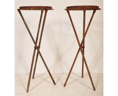 A matching pair of vintage 20th Century garden planters / plant stands of cast iron construction having a rounded top for ins