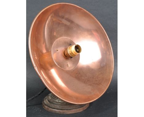 An early 20th Century Art Deco copper and cast iron heat lamp converted to a table lamp light having a UFO copper shade raise