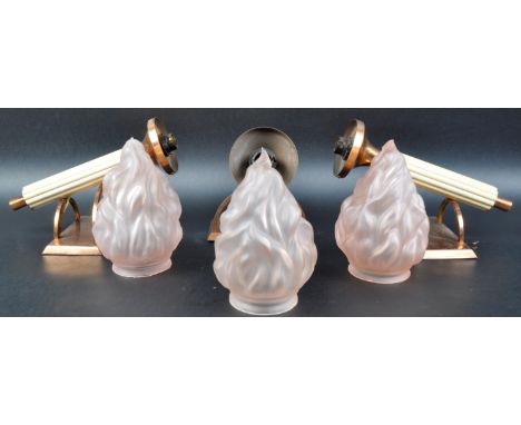 A matching set of three 20th Century Art Deco copper plated wall sconces with each having peach frosted glass flame shades su
