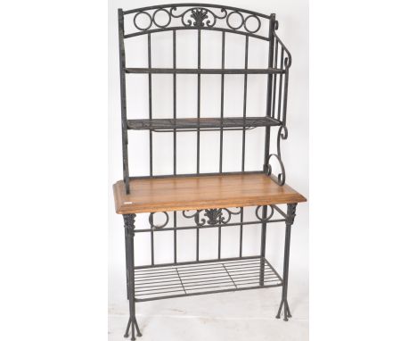 A contemporary French style bakers rack having a wrought iron frame finished in black with paneled oak shelf with metal shelv