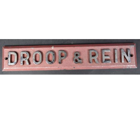 A 20th Century heavy cast steel German sign for the manufacturing company Droop &amp; Rein. Painted pink metallic background 