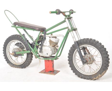 A retro vintage 20th Century advertising shop display point of sale motorbike having been converted in to a juvenile fairgrou