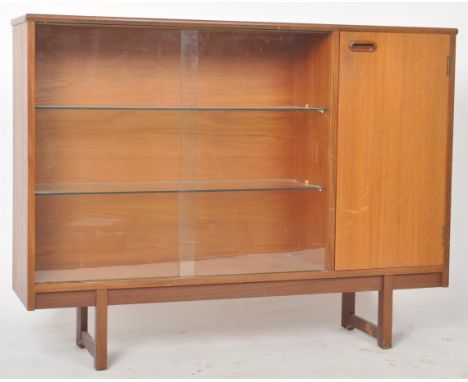 A retro mid 20th Century Danish influenced teak wood bookcase cabinet having a three quarter length twin glass sliding door d