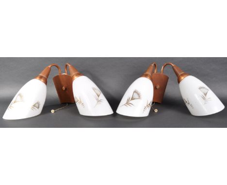 A pair of retro mid 20th Century wall light sconces with each having twin milk glass shades with leaf detailing supported by 