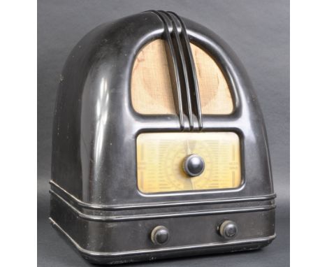 A vintage 20th Century Art Deco Bakelite case valve radio of domed form with speaker front and tuner below. Dark brown colour