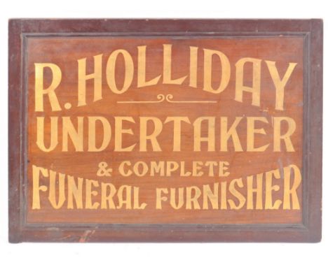 An Edwardian mahogany funeral directors sign reading " R. Holliday, Undertaker &amp; Complete Funeral Furnisher". No signs of