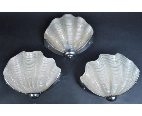A matching set of three vintage Art Deco clam shell frosted glass wall sconce lamp lights. Each with chrome wall mounts. Each