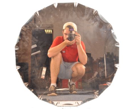 A vintage 20th Century Art Deco peach glass hanging mirror of circular form having beveled edge decoration with all mounted u