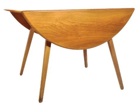 Ercol - A retro vintage mid 20th Century beech and elm drop leaf dining table having a chamfered edge to the circular table t
