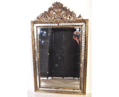 A large vintage 20th Century Venetian style hanging mirror having a gilt plaster urn and scroll pediment top with further gil