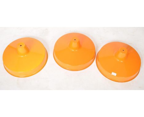 A matching set of three contemporary UFO style aluminum pendant light shades finished in orange. Each measures approx; 20cm x