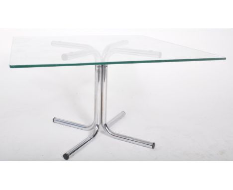 A retro 20th Century 1980s chrome and glass topped coffee table / low table. Square clear glass top raised on an X-framed spl