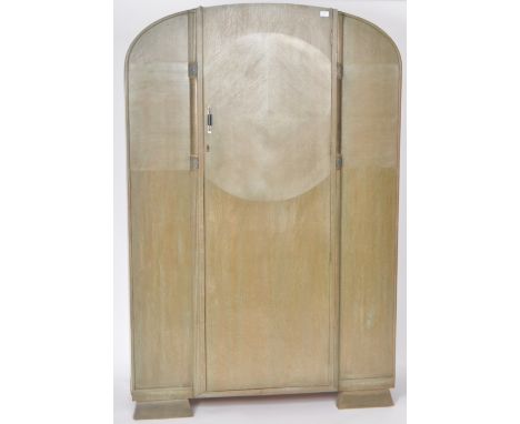 A vintage 20th Century Art Deco stained oak wardrobe of domed form having a single door opening to reveal a spacious interior