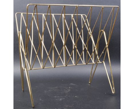 A retro mid 20th Century tubular brass magazine rack raised on atomic space age supports. Measures approx; 38cm x 40cm x 27cm