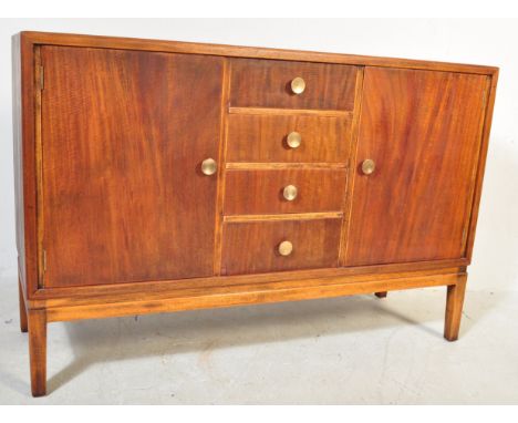 A retro mid 20th Century teak sideboard credenza in the manner of Gordon Russell having a central bank of four drawers flanke
