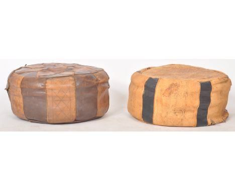 Two vintage 20th Century&nbsp;Moroccan leather&nbsp;footstool / pouffes with each having patterned decorations throughout. On