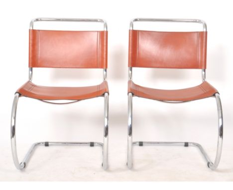 A matching pair of late 20th Century chrome and leather cantilever dining chairs / sides chairs with each having tubular fram