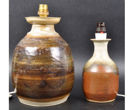 Two retro 20th Century studio art pottery table lamps with each having a waisted necks and bulbous bodies. Each with earthen 