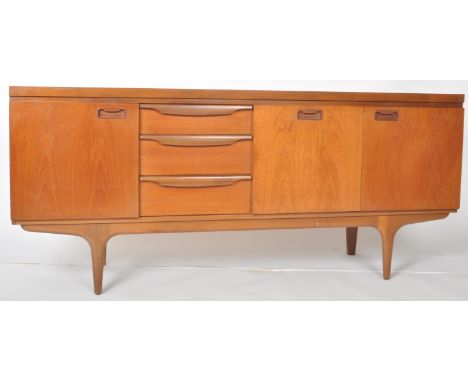 Greaves &amp; Thomas - A retro vintage 20th Century teak wood sideboard credenza raised on tapered legs and shaped frieze hav