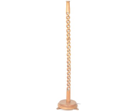 A retro mid 20th Century teak standard lamp light / uplighter of one piece carved teak construction. Twisted stem with all ra