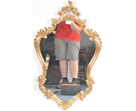A vintage 20th Century Hollywood Regency gilt frame pier mirror / hallway mirror having a shaped mirror plate with decorative