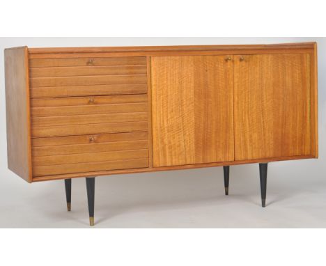 A retro mid 20th Century British design teak wood sideboard credenza having a bank of three drawers to the left with each hav