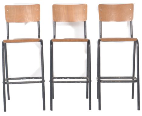 A matching set of three retro 20th Century bar stools / science lab high chairs with each having bentwood panel back and seat