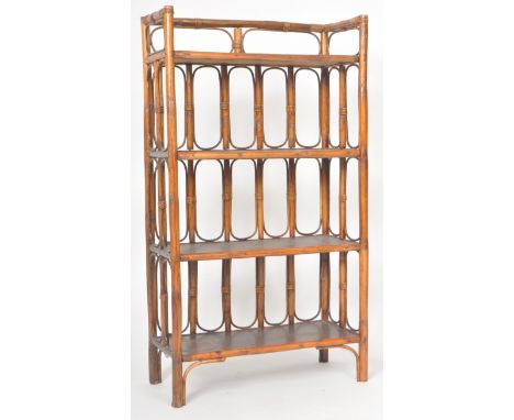 A retro vintage 20th Century stained bamboo and cane open bookcase having four shelves with open bamboo worked side and back.