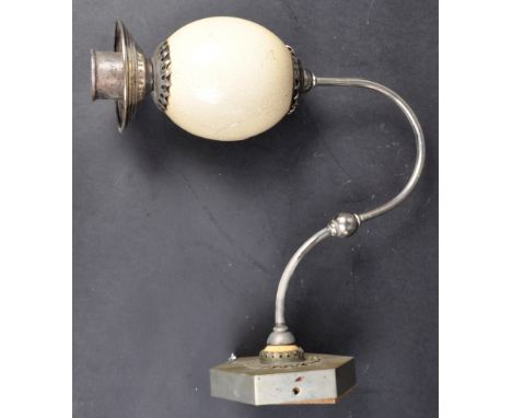 A vintage 20th Century Ostrich egg wall sconce lamp light having a circular stepped chromed shade with simulated ceramic Ostr