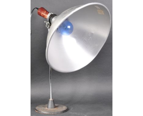 A retro vintage 20th Century hand held light having a pendant aluminium shade and wooden handle. Mounted upon a vintage micro