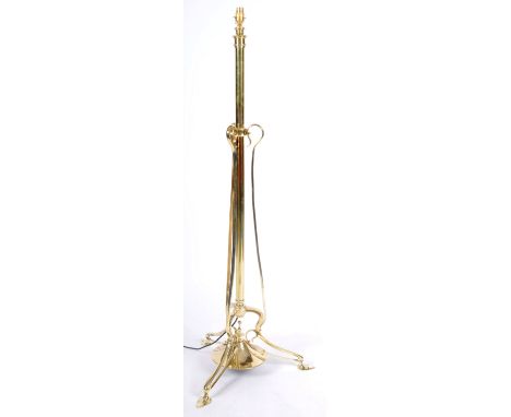 A late 19th Century Art Nouveau polished brass floor standing standard lamp light having a central cylindrical column with tr