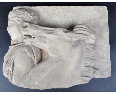 A contemporary cast resin wall plaque in the style of a Classical Roman carved stone example featuring the side profiles of a