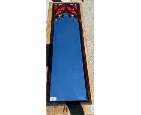 A vintage 20th Century Gothic style oak framed mirror of slender form having a carved decorated top of classic ecclesiastical