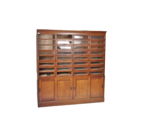 A large 19th Century Victorian mahogany haberdashery shop fitting display cabinet having 32 glazed fronted doors with each ha