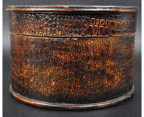 An early 20th Century Art Deco faux crocodile skin wooden hat box of cylindrical form having a fitted cover and felt lined in