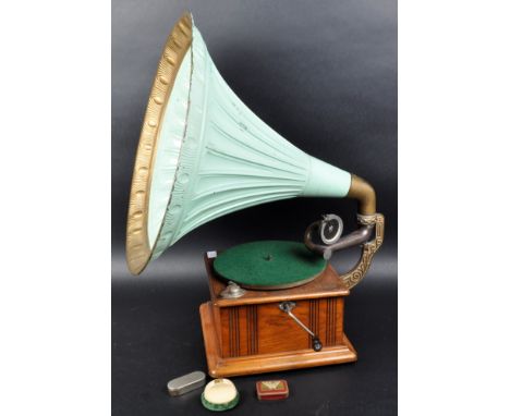 A vintage early 20th Century gramophone record player having a large mint green painted speaker over an oak turntable base. M