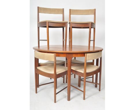 A. H. Mcintosh &amp; Co - A retro mid Century dining table and matching six chairs. The expendable dining table of circular f