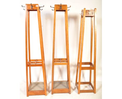 A matching pair of retro vintage mid Century oak framed Industrial office / school coat hook hall stands having four cast met