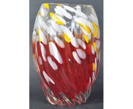 A retro 20th Century thick studio art glass vase of ovoid twist form with fading red tones with white and yellow polka dot de